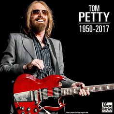 a man holding a red guitar in front of a black background with the words tom petty 1950 - 2011