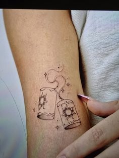 a woman's arm with tattoos on it