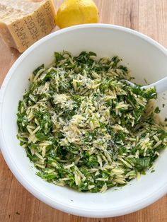 a white bowl filled with pasta and greens