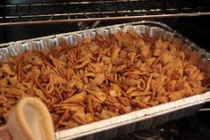 a pan filled with food sitting on top of an oven