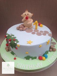 a birthday cake with a teddy bear on top