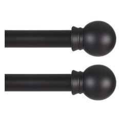 pair of black curtain rods with round top and ball finials on each end