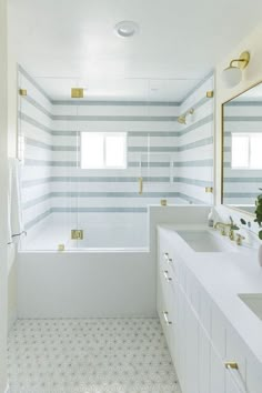 a bathroom with two sinks and a bathtub