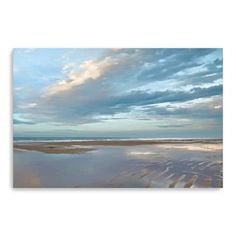 the sky is reflected in the wet sand