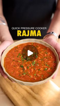 a person holding a bowl of food on top of a wooden table with the words quick pressure cooker raga