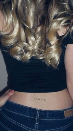 the back of a woman's stomach with her name written on it in cursive writing