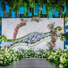 an artistic backdrop with flowers and greenery