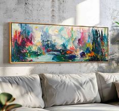 a painting hanging on the wall above a couch