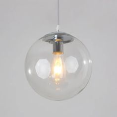 a clear glass globe light hanging from a ceiling