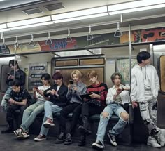 group of young men sitting on the subway