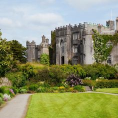 an old castle is surrounded by greenery and trees