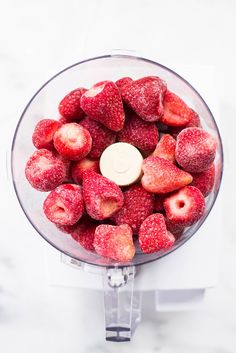 fresh strawberries in a food processor ready to be blended into ice cream or jelly