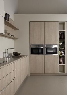 a kitchen with two ovens and cabinets in it