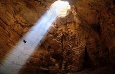 the light shines brightly through an opening in a cave