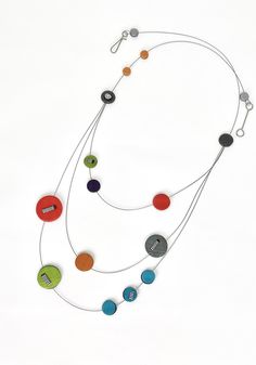 Steel & Polymer Necklace - A cascade of polymer clay dots appears to float on this colorful, tiered Arden Bardol necklace. The double-sided design offers a colorful primary color palette on one side, and black, white, and red accents on the other. Plastic-coated stainless-steel wire. Each piece in this collection is unique and will vary slightly in color and length. Felt Jewelry Necklace, Teen Necklaces, Unusual Necklace, Polymer Inspiration, Felt Jewelry, Stainless Steel Wire, Disc Necklace, Polymer Jewelry, Red Accents