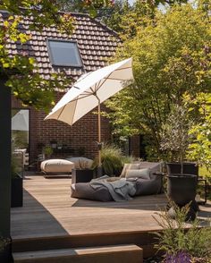 a patio with an umbrella and some plants