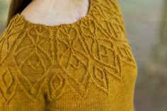 a close up of a woman wearing a sweater