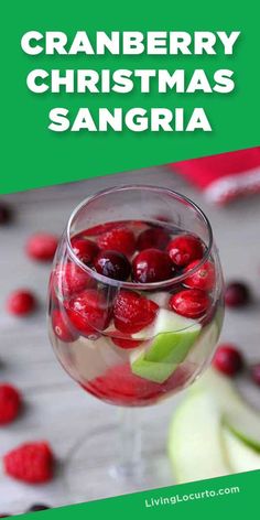 a glass filled with cranberry cocktail next to christmas ornaments