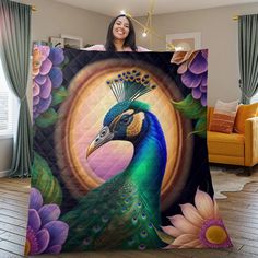 a woman is holding up a peacock blanket