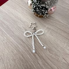 a christmas ornament sitting on top of a wooden table next to a potted plant