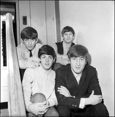 the beatles posing for a photo in their home