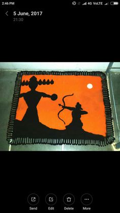 an orange and black cake with the silhouettes of two people on it's side