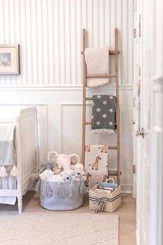 a baby's room with a ladder, crib and stuffed animals