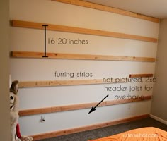 a bed room with a neatly made bed and some wooden shelves on the wall above it