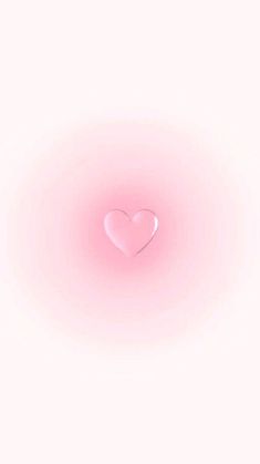 a heart shaped object floating on top of a white surface with light pink hues