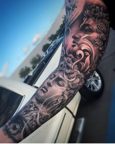 a man's arm with tattoos on it and an image of a face in the middle