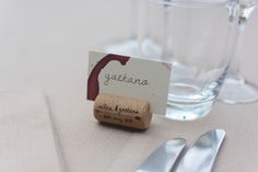 a place card is placed on a table with silverware