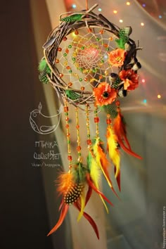 a colorful dream catcher with feathers and beads