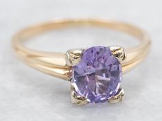 a close up of a ring with a purple stone