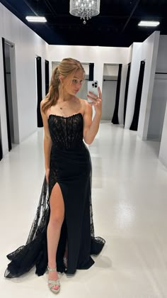 Black prom dress with a sheer corset bodice and floral lace overskirt. Dress By: Ellie Wilde prom prom 2024 prom dress prom 24 black prom dress corset prom dress prom dress with slit Black Prom Dress Corset Top, Black Prom Dress Corset, Grad Dresses Black, Black Prom Dress Lace, Black Corset Prom Dress, Simple Black Prom Dress, Prom Inspo Pics, Overskirt Dress, Grade Dresses