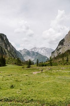 an open field with mountains in the background