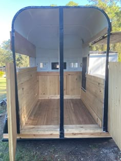 the inside of a horse trailer with wood flooring and walls in place for storage