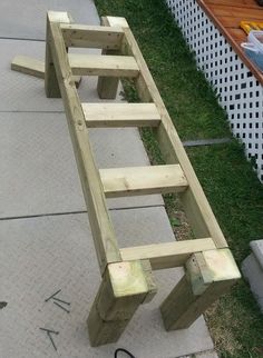 a wooden bench sitting on top of a sidewalk