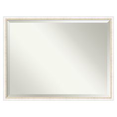 a white and gold framed mirror on a wall