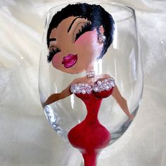 a wine glass with an image of a woman in a red dress