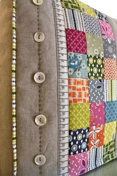 a close up of a pillow with buttons on the front and back of it's sides