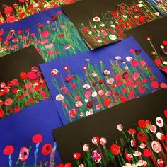 several different pictures of flowers and grass on blue paper with red, white, and green designs