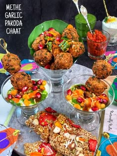 there are many different foods in bowls on the table