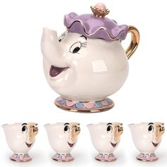 the teapot has five cups in it and is shaped like an elephant's head