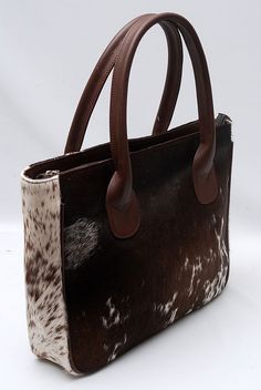 Stylish cowhide fur purse in tricolor pattern for everyday use or gifting – custom-made for a chic and unique touch. - Free shipping offered on all our cowhide fur purses - Crafted exclusively from premium hair-on cowhide. - Both sides cowhide fur. - Features durable leather handles for added elegance - Lined with cotton/satin, including an inside pocket and zipper pocket - Exquisite craftsmanship defines this structured handbag - Measurements: 15' L x 13' H x 5' W - A versatile cowhide fur tote Cowhide Bags Handbags, Austin Apartment, Rodeo Style, Shoulder Purses, Cowhide Purse, Cowhide Handbags, Purse Crafts, Fur Purse, Note Image