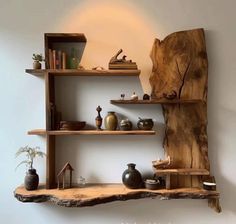 a wooden shelf with books and vases on it