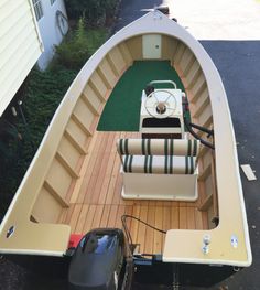 the inside of a small boat with two seats and a side table on the deck