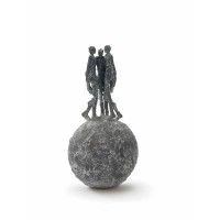 three figurines standing on top of a small ball with one man holding the other's hand