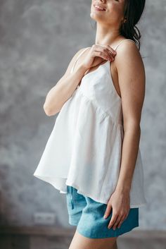 Perfect for the summer, this breathable, free-flowing linen cami is the ideal wardrobe staple for the warm months and long evenings. This strapless white blouse is modestly lined in the chest with a loose, flowy hem. Perfect to wear for a picnic in the park or on a cocktail date with your girls!Made from washed linen, this strappy top is not only durable but gets softer after every wash! ***The Prancing Hare is the sister brand of Bunny Street, which was launched by Irene Sheyko in 2013. Drawing White Linen Tank Top For Day Out, White Linen Cami Top, White Linen Beach Crop Top, Casual Linen V-neck Crop Top, Summer Linen Crop Top With V-neck, Linen Cami, Bridal Dressing Gown, Linen Gown, Strappy Tank Top