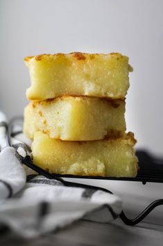 three pieces of cake sitting on top of a black and white cloth next to a fork