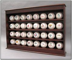 a wooden display case with baseballs on it